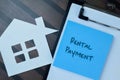 Concept of Rental Payment write on sticky notes isolated on Wooden Table Royalty Free Stock Photo