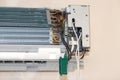 Concept of repair and maintenance of air conditioners. Radiator detail with copper tubes and plates. Technician fixing the air