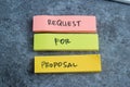 Concept of Request for Proposal write on sticky notes isolated on Wooden Table Royalty Free Stock Photo