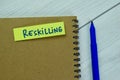 Concept of Reskilling write on sticky notes isolated on Wooden Table Royalty Free Stock Photo