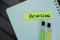 Concept of Reskilling write on sticky notes isolated on Wooden Table Royalty Free Stock Photo
