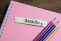 Concept of Reskilling write on sticky notes isolated on Wooden Table Royalty Free Stock Photo