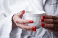 A cup in the hands of a girl in a white coat, close-up. The concept of rest in a hotel Royalty Free Stock Photo