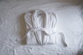 The concept of rest in a hotel. Terry white bathrobe on the bed, top view Royalty Free Stock Photo