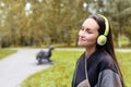 Young happy woman listening music from smartphone with headphones in a quiet Park Royalty Free Stock Photo