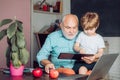Concept of a retirement age. Elementary school and education. Portrait of grandfather and grandson on blackboard in Royalty Free Stock Photo