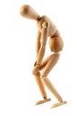 Wooden mannequin with knee pain on white background Royalty Free Stock Photo