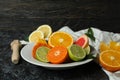 Concept of ripe food with different citrus on black smoky table