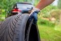 Concept of road accident. the hand of the master in a blue glove holds the torn old tire with wire. close up. on the