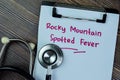 Concept of Rocky Mountain Spotted Fever write on paperwork isolated on Wooden Table Royalty Free Stock Photo