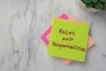 Concept of Roles and Responsibilities write on sticky notes isolated on Wooden Table Royalty Free Stock Photo