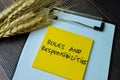 Concept of Roles and Responsibilities write on sticky notes isolated on Wooden Table Royalty Free Stock Photo