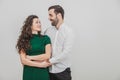 Portrait of beautiful smiling couple posing at studio over white background. Royalty Free Stock Photo