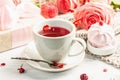 The concept of romantic tea. Wrapped gift, hibiscus tea, a bouquet of delicate roses, sweets Royalty Free Stock Photo