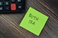 Concept of ROTH IRA write on sticky notes isolated on Wooden Table Royalty Free Stock Photo