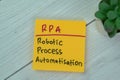 Concept of RPA - Robotic Process Automatisation write on sticky notes isolated on Wooden Table Royalty Free Stock Photo