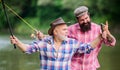 Concept of a rural getaway. hobby. Fly Fishing Time. Camping on the shore of lake. hunting tourism. father and son Royalty Free Stock Photo