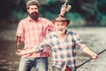 Concept of a rural getaway. hobby. Fly Fishing Time. two happy fisherman with fishing rod and net. Camping on the shore Royalty Free Stock Photo