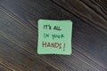 Concept of It`s All In Your Hands! write on sticky notes isolated on Wooden Table Royalty Free Stock Photo