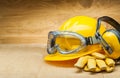 Concept of safety. construction safety tools. yellow construction helmet leather gloves and earphones Royalty Free Stock Photo