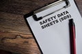 Concept of Safety Data Sheets - SDS write on paperwork isolated on Wooden Table Royalty Free Stock Photo