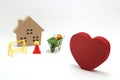 Concept of safety image. Red heart shaped wood, house and construction tools of miniature on white back ground. Royalty Free Stock Photo