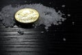 Concept: salt and gold. Gold coin American Eagle 1 ounce compared to salt as a value of life. Gold coin, coarse salt arranged on a Royalty Free Stock Photo