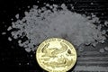 Concept: salt and gold. Gold coin American Eagle 1 ounce compared to salt as a value of life. Royalty Free Stock Photo