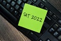 Concept of Sat 2022 - Scholastic Asessment Test 2022 write on sticky notes isolated on Wooden Table