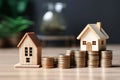 Miniature house wooden model on a stack of coins.