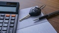 The concept of saving money. Saving money to buy a car and repairs.Miniature car model,calculatorand Financial statement with