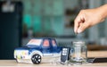 Concept of savings and financial planning of car leasing. Man`s hand putting coins in a glass jar, Business, finance or budget Royalty Free Stock Photo