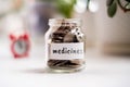 Concept of savings on medicines - Glass jar with coins and an inscription