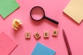 Concept of searching idea. Business flat lay with sticky notes, crumpled paper, magnifying glass, pen and word IDEA made from Royalty Free Stock Photo