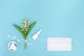 Concept of seasonal spring and summer allergies to flowering. White nasal spray and pills, face surgical mask Royalty Free Stock Photo