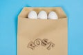 The concept of secure courier service, reliable postal company. Abstract image of eggs in an envelope and the word mail, post.