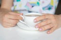 The concept of self-care, beauty. Women& x27;s hands with a neat manicure of nude color. Fingers holding a cup of tea