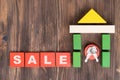 The concept of selling real estate. The word SALE on red wooden cubes. Keys inside a wooden house made of blocks, copy space Royalty Free Stock Photo