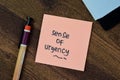 Concept of Sense of Urgency write on sticky notes isolated on Wooden Table