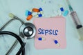 Concept of Sepsis write on sticky notes isolated on Wooden Table