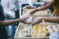 The concept of sharing food to hungry and starving people : Volunteers are handing out food to the poor