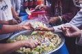 The concept of sharing food to hungry and starving people : Volunteers are handing out food to the poor