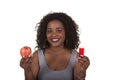 Concept shoot about health care of a woman choosing between an apple and a pill bottle Royalty Free Stock Photo