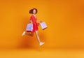 Concept of shopping purchases and sales of happy   girl with packages  on yellow background Royalty Free Stock Photo