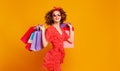 Concept of shopping purchases and sales of happy  woman with packages  on yellow background Royalty Free Stock Photo