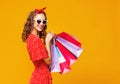 Concept of shopping purchases and sales of happy  woman with packages  on yellow background Royalty Free Stock Photo