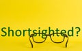 Concept about shortsighted depicted with glasses and blurred text