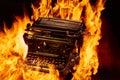 Concept shot of antique manual typewriter with paper burning on black background, selective focus Royalty Free Stock Photo