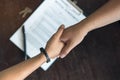 Close up above view of Businessman and client shaking hands after contract agreement done deal. Royalty Free Stock Photo