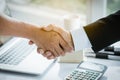 Close up above view of Businessman and client shaking hands after contract agreement done deal. Royalty Free Stock Photo